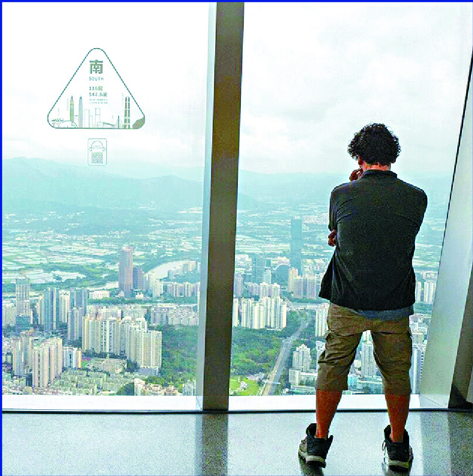 A visitor looks out from the observation deck of the Ping An Finance Center in Shenzhen. BLOOMBERG A visitor looks out from the observation deck of the Ping An Finance Center in Shenzhen. BLOOMBERG