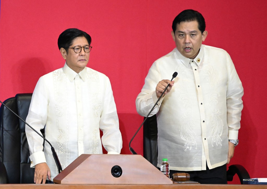 This photo taken on July 28, 2025 shows Philippine President Ferdinand Marcos (L) listening to Speaker of the House Martin Romualdez (R) in the upper rostrum during the State of the Nation Address at the House of Representatives in Manila. The speaker of the Philippine House of Representatives tendered his resignation on September 17, 2025 after his name surfaced in a mounting corruption scandal, less than two weeks after the country's Senate president suffered the same fate. (Photo by Ted ALJIBE / AFP)