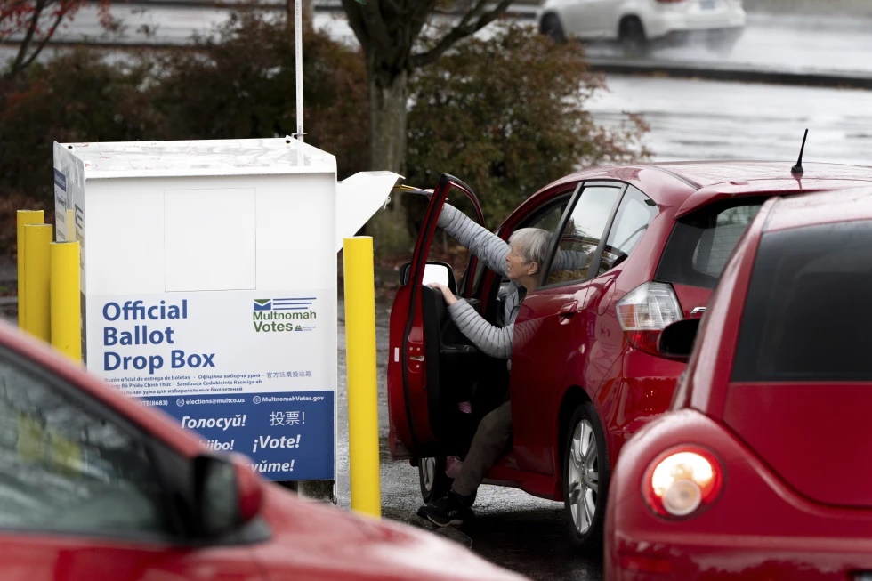 A voter drops off their ballot at a dropbox on Election Day, Nov. 5, 2024, in Portland, Ore. (AP Photo/Jenny Kane, File)