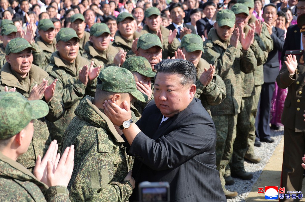 Photo by STR / KCNA VIA KNS / AFP  This picture taken on October 23, 2025 and released by North Korea's official Korean Central News Agency (KCNA) via KNS on October 24, 2025 shows North Korean leader Kim Jong Un (C) encouraging soldiers of the Overseas Military Operations Forces at the groundbreaking ceremony for building the Memorial Museum of Combat Feats at the Overseas Military Operations in Pyongyang.