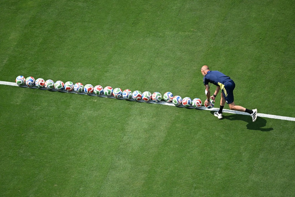 A Sweden staff member organizes the balls during warm-ups ahead of the 2026 World Cup round of 32 football match between France and Sweden at the New York/New Jersey Stadium in East Rutherford on June 30, 2026. (Photo by MAURO PIMENTEL / AFP)