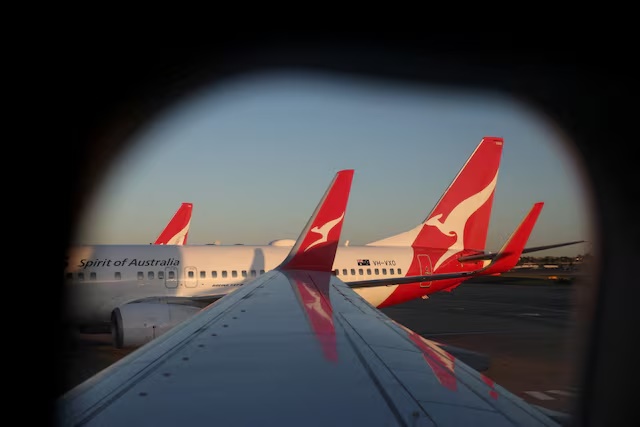 A Qantas logo is visible on the tail of an aeroplane at an airport in Sydney, Australia, September 18, 2025. REUTERS/Hollie Adams/File Photo