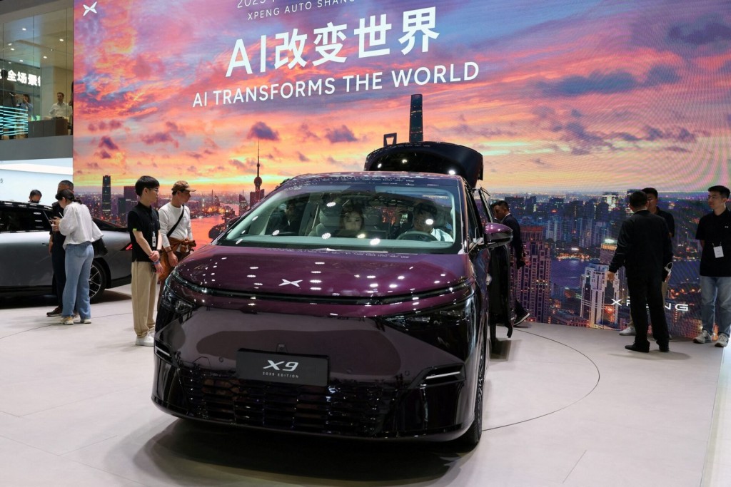 People look at an Xpeng X9 minivan at the Chinese electric vehicle (EV) maker's booth during a media day for the Auto Shanghai show in Shanghai, China April 23, 2025. REUTERS