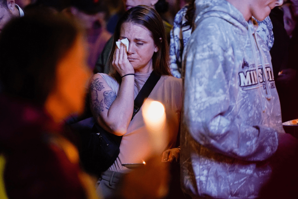 A woman reacts as people take part in a vigil for victims of the Silver Rail Elementary School shooting, the day after a shooting, in Bend, Oregon, U.S., October 16, 2026. REUTERS/David Ryder