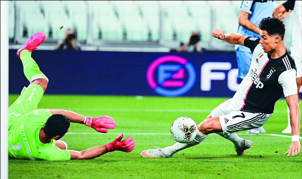 Cristiano Ronaldo tries to lift the ball past Lazio goalkeeper Thomas Strakosha and into the net during the match in Turin. AP Cristiano Ronaldo tries to lift the ball past Lazio goalkeeper Thomas Strakosha and into the net during the match in Turin. AP
