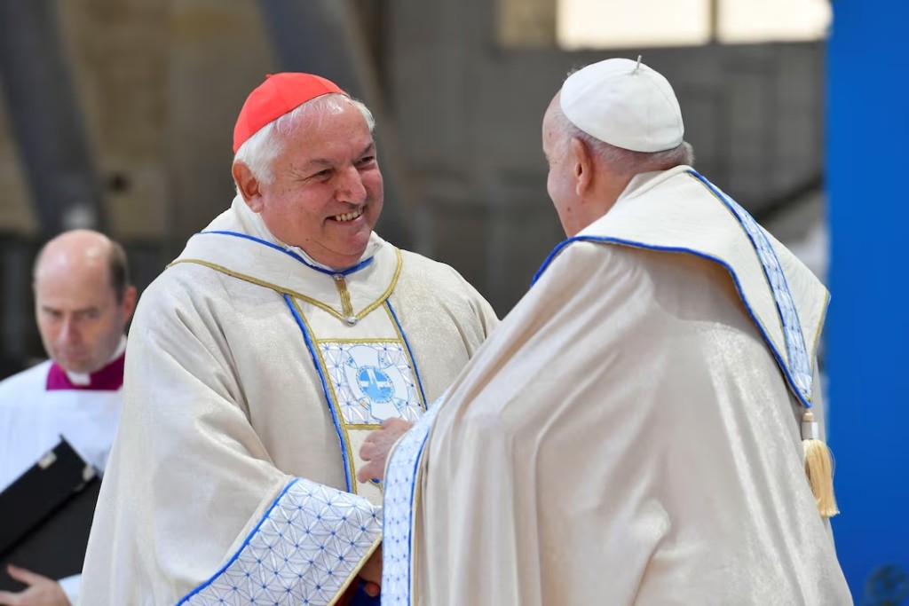 Pope Francis speaks to Marseille's archbishop Cardinal Jean-Marc Aveline, at a mass at the Velodrome Stadium, as a part of his journey on the occasion of the Mediterranean Meetings (MED 2023) in Marseille, France, September 23, 2023. Vatican Media/­Handout via REUTERS/File Photo