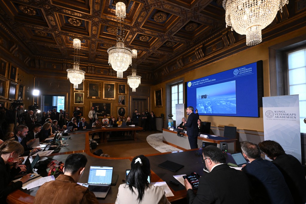 Mark Pearce (R), member of the Nobel Committee for Physics, speaks next to Eva Olsson (L) and Ellen Moons during the announcement of the 2026 Nobel Prize in Physics, awarded to Belgian physicist Francis Halzen, at the Royal Swedish Academy of Sciences in Stockholm, Sweden, on October 6, 2026. (Photo by Jonathan Nackstrand / AFP)