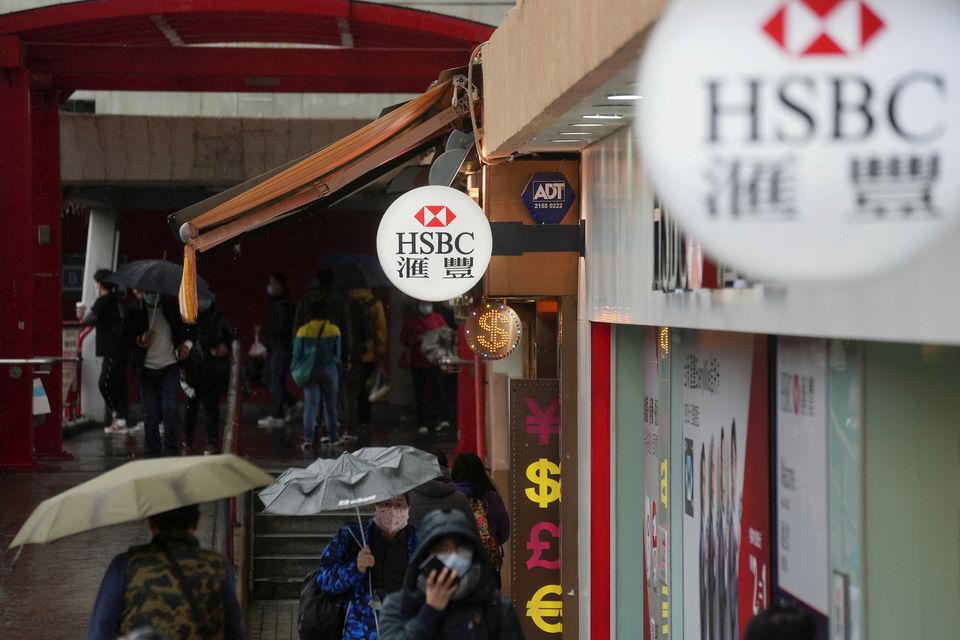 Pedestrians wearing face masks following the coronavirus disease (Covid-19) outbreak, walk past a HSBC bank branch in Hong Kong, China. (Reuters) Pedestrians wearing face masks following the coronavirus disease (Covid-19) outbreak, walk past a HSBC bank branch in Hong Kong, China. (Reuters)