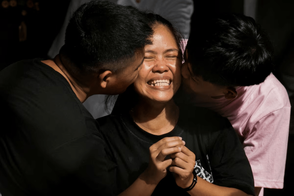 Philippine drug convict and former death row inmate Mary Jane Veloso is kissed by her sons at the Correctional Institution for Women in Mandaluyong City, Metro Manila, Philippines, December 18, 2024. REUTERS/Lisa Marie David
