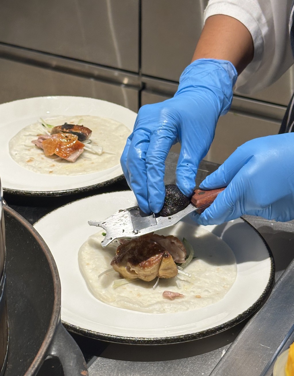 Duck Foie Gras & Peking Duck with shaved summer black truffle is prepared at the live stations.
