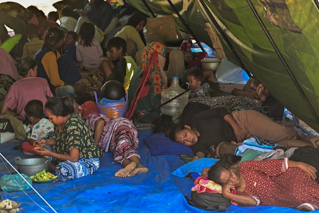 Villagers rest in a tent on an open field in Marapokot, Nagekeo, East Nusa Tenggara, on August 17, 2026, following a 7.7-magnitude earthquake. (AFP)