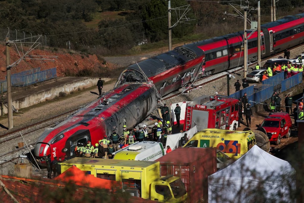  Members of the Spanish Civil Guard, along with other emergency personnel, work next to one of the trains involved in the accident, at the site of a deadly derailment of two high-speed trains near Adamuz, in Cordoba, Spain. REUTERS/Susana Vera