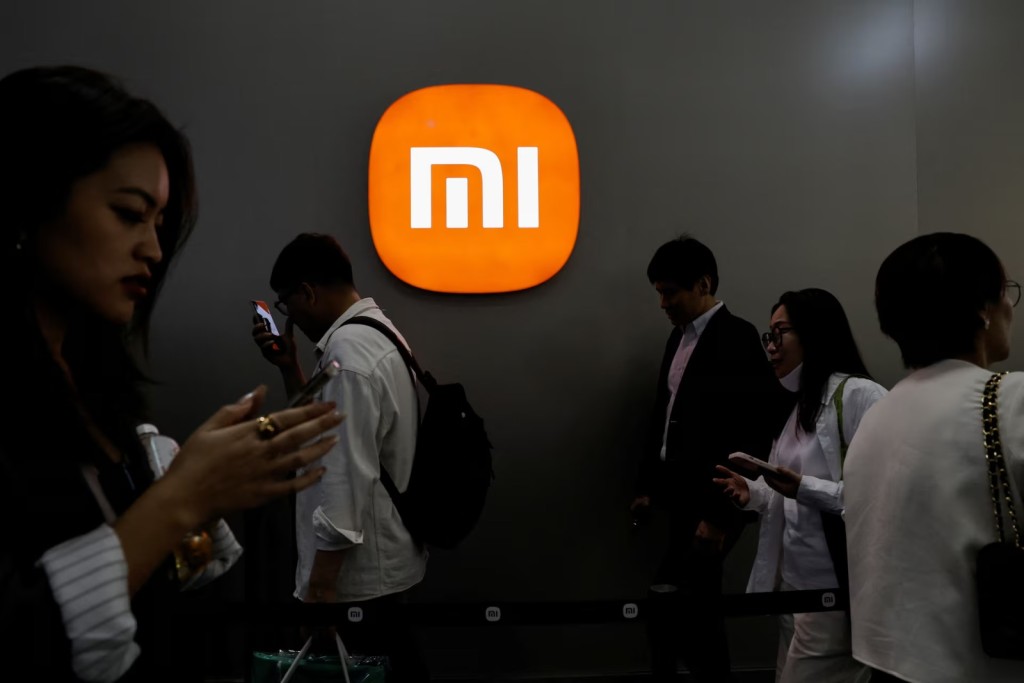 Visitors walk past a Xiaomi logo at the Beijing International Automotive Exhibition, or Auto China 2024, in Beijing, China, April 25, 2024. REUTERS