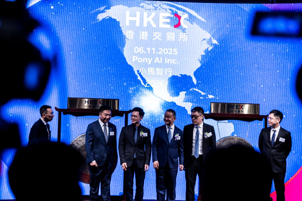 Photo by ISAAC LAWRENCE / AFP  People attend the initial public offering (IPO) launch of Pony.