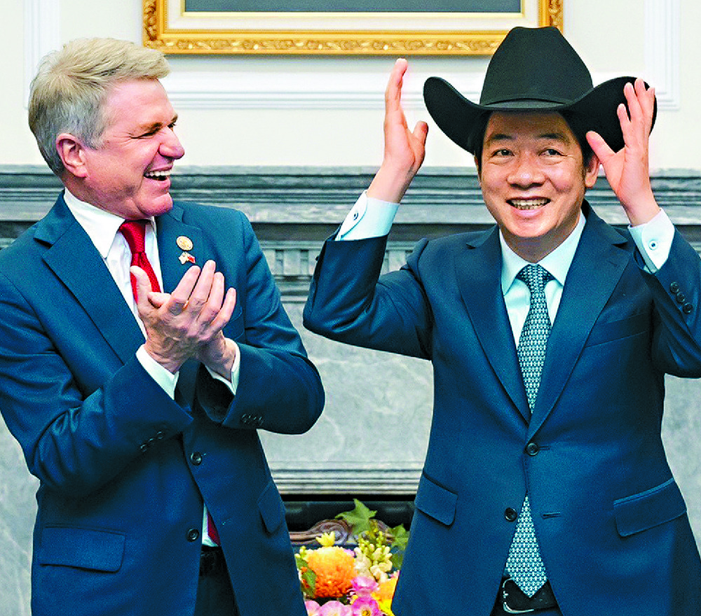 Michael McCaul guffaws as Lai Ching-te tries on a cowboy hat. AFP Michael McCaul guffaws as Lai Ching-te tries on a cowboy hat. AFP