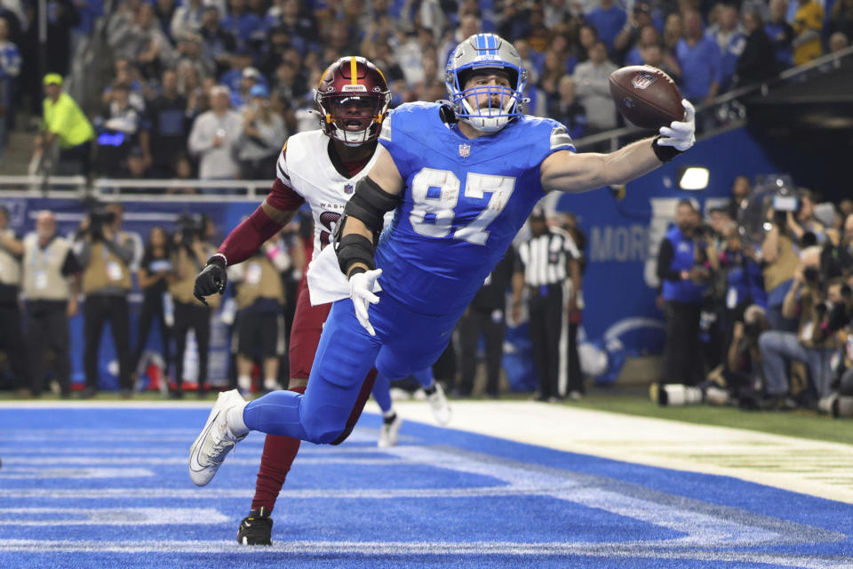 Detroit Lions tight end Sam LaPorta (87) catches a two-yard touchdown pass as Washington Commanders safety Percy Butler (35) defends during the first half of an NFL football divisional playoff game, Saturday, Jan. 18, 2025, in Detroit. (AP Photo/Mike Mulholland)ASSOCIATED PRESS