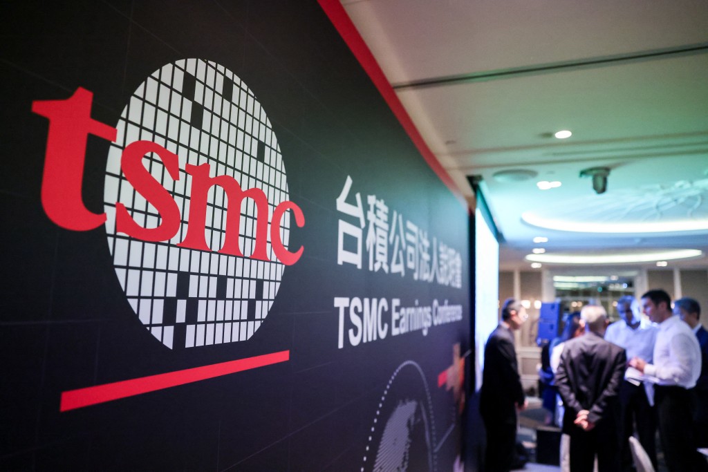 Photo by I-HWA CHENG / AFP  The logo of Taiwan Semiconductor Manufacturing Company (TSMC) is seen during its 2026 second quarter earnings conference ,in Taipei on July 16, 2026.