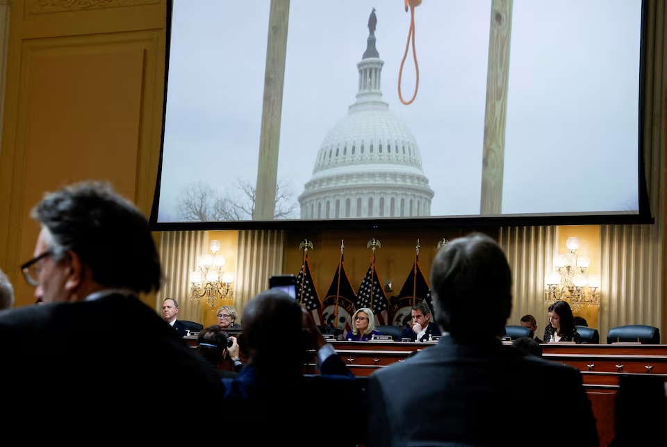An image of a hangman's noose hanging from a gallows, that was set up outside the U.S. Capitol building on January 6, 2021 by rioters, is displayed over the U.S. House Select Committee investigating the January 6 Attack on the U.S. Capitol and Republican members Rep. Liz Cheney (R-WY) and Adam Kinzinger (R-IL) as the committee holds their final public meeting on Capitol Hill in Washington, U.S., December 19, 2022. REUTERS/Evelyn Hockstein/File Photo
