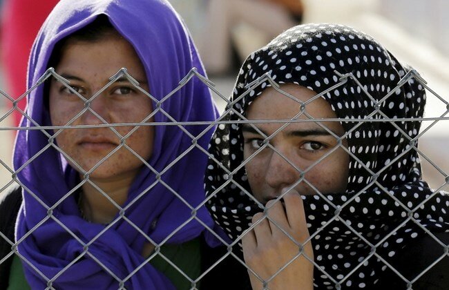 Yazidi women - from a non-Muslim tribe of people in the Levant who were almost all but wiped out during Isis’ reign of terror in the region - stand behind a wire fence in a refugee camp in Greece. (via Nadia’s Initiative) Yazidi women - from a non-Muslim tribe of people in the Levant who were almost all but wiped out during Isis’ reign of terror in the region - stand behind a wire fence in a refugee camp in Greece. (via Nadia’s Initiative)