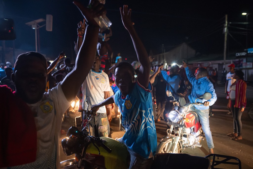 Photo by JOSPIN MWISHA / AFP. Congolese supporters celebrate the Leopards' equalizing goal in a street in Bunia at night during a FIFA World Cup match between DR Congo and Portugal in Bunia, Ituri Province, Democratic Republic of Congo, on June 17, 2026.