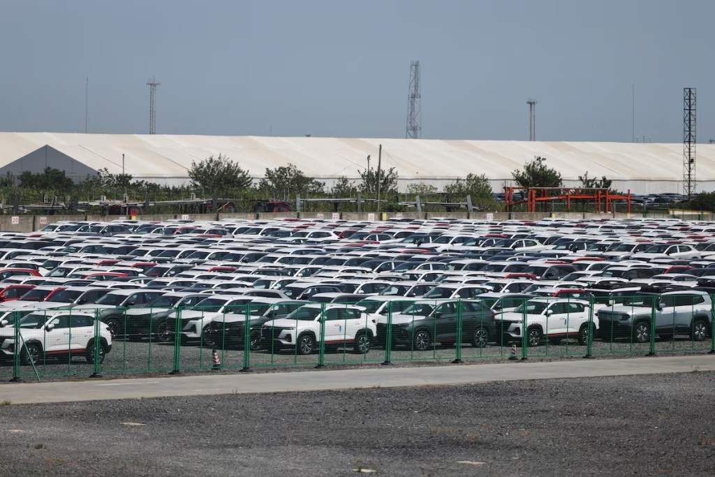 New cars are stored at a parking lot in Shanghai, China, September 8, 2025. REUTERS