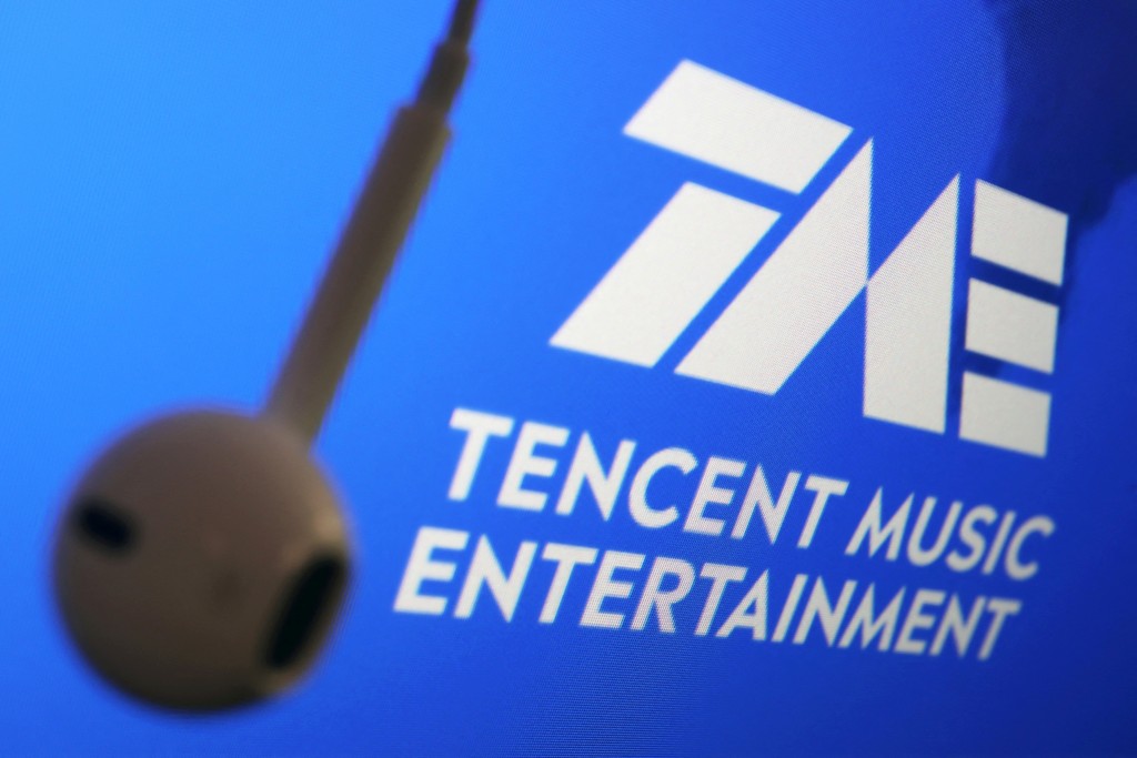 The logo of China's Tencent Music Entertainment Group is seen next to an earphone in this illustration picture taken March 22, 2021. REUTERS