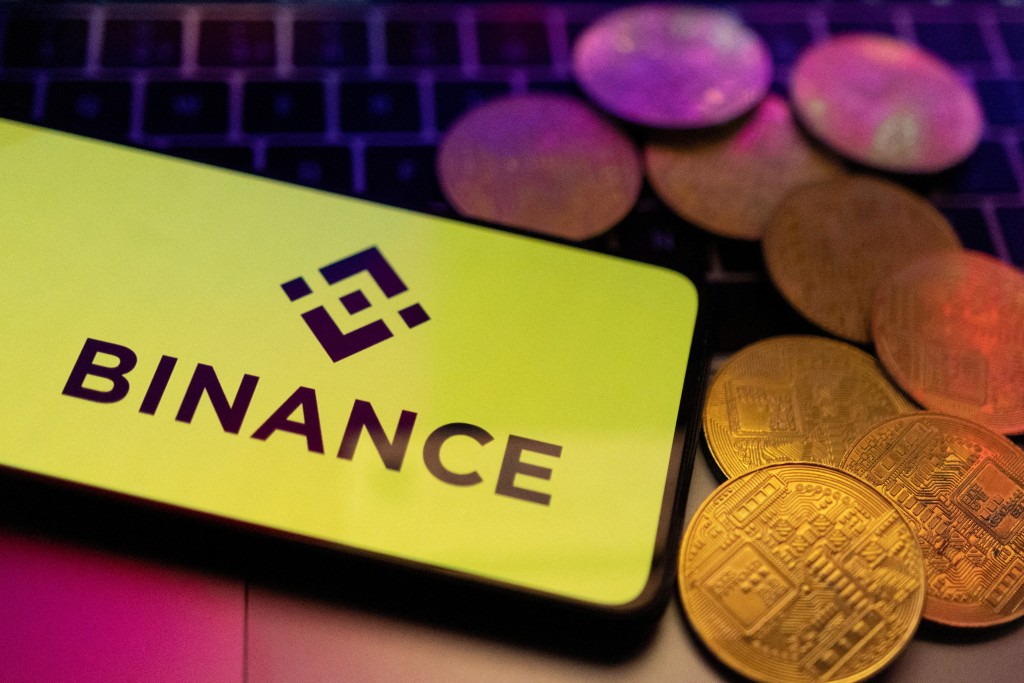 A smartphone with displayed Binance logo and representation of cryptocurrencies are placed on a keyboard in this illustration taken, June 8, 2023. REUTERS/Dado Ruvic/Illustration