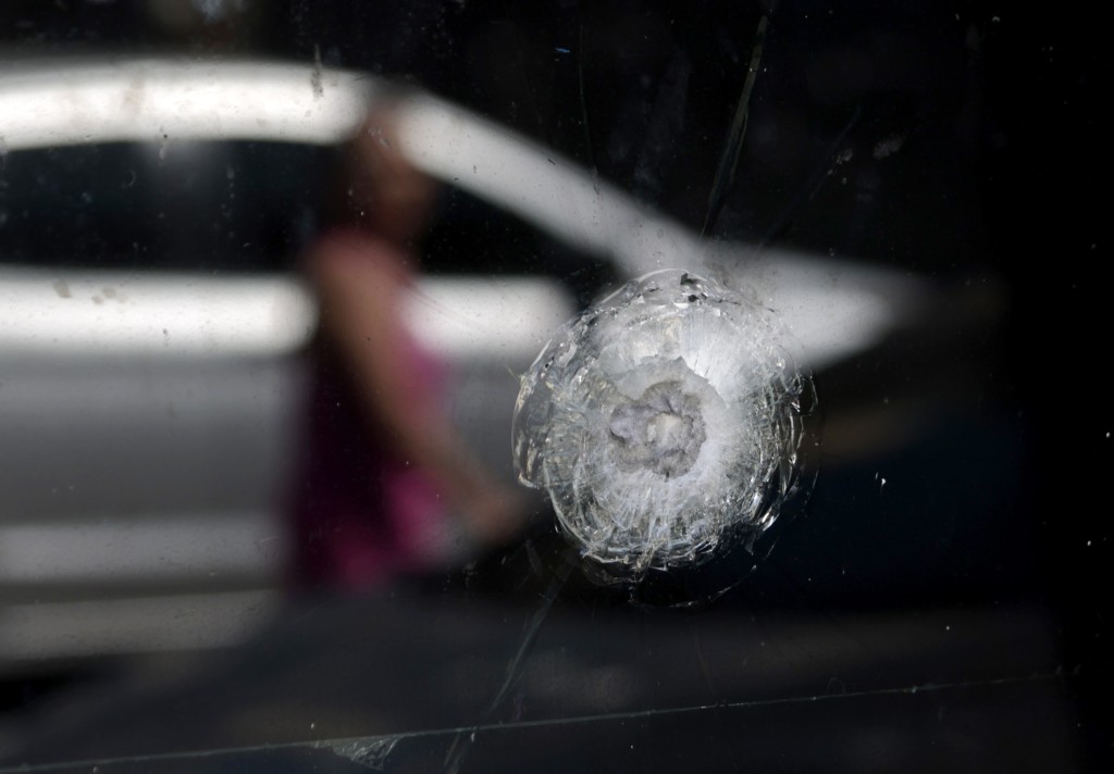 Photo by ULISES RUIZ / AFP  View of a bullet impact on the window of a police station in Guadalajara, Jalisco, Mexico, on February 23, 2026, a day after clashes.
