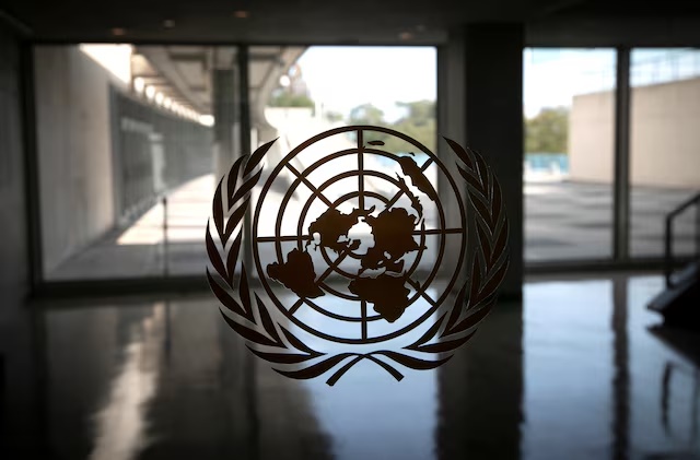 The United Nations logo is seen on a window in an empty hallway at United Nations headquarters during the 75th annual U.N. General Assembly high-level debate, which is being held mostly virtually due to the coronavirus disease (COVID-19) pandemic in New York, U.S., September 21, 2020. REUTERS/Mike Segar/File Photo