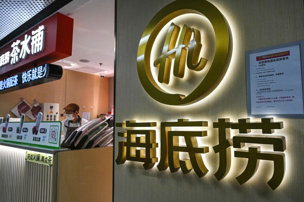 The logo of Haidilao hot pot restaurant is seen at a shopping mall complex in Beijing on March 13, 2025. AFP