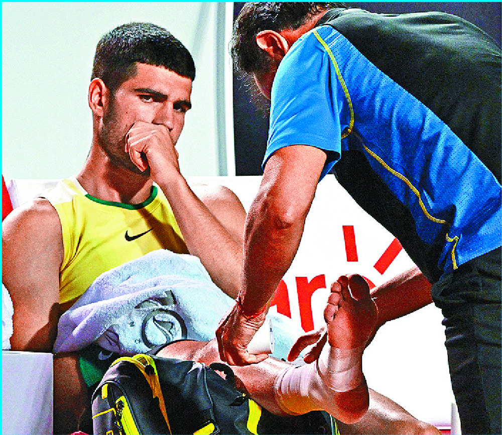 Carlos Alcaraz receives on-court treatment. AFP Carlos Alcaraz receives on-court treatment. AFP