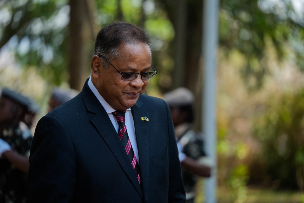 Madagascar’s newly appointed Prime Minister Herintsalama Rajaonarivelo walks on after inspecting the guard of honour during his inauguration at the Prime Minister's Palace in Mahazoarivo, Antananarivo, on October 22, 2025. (Photo by Mamyrael / AFP)