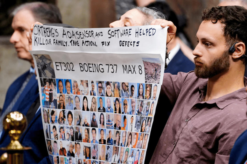 People hold a banner with pictures of victims of crashed Ethiopian Airlines flight 302 Boeing 737 MAX 8 during Senate Commerce, Science, and Transportation Committee hearing about Boeing’s commitment to address safety concerns in the wake of a January 2024 mid-air emergency involving a new 737 MAX, on Capitol Hill in Washington, D.C., U.S., April 2, 2025. REUTERS/Ken Cedeno/File Photo