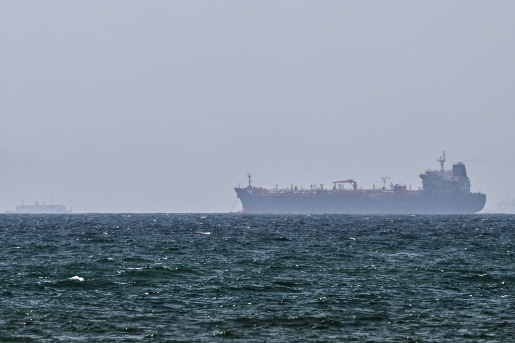 Photo by - / AFP. A vessel is anchored off the coast of Sharjah in the United Arab Emirates on May 21, 2026.