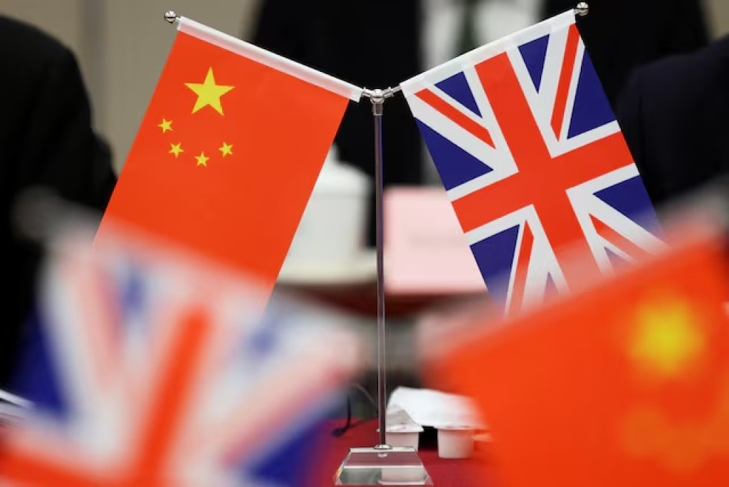 Flags of China and the Union Jack stand during the China-UK Energy Dialogue in Beijing, China March 17, 2025. REUTERS/Florence Lo/Pool