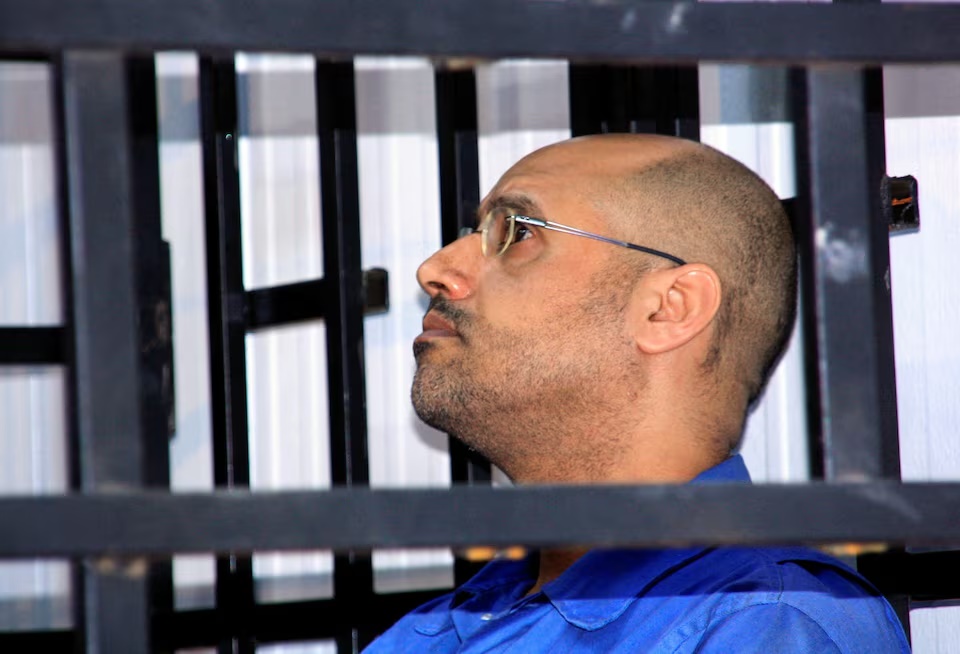  Saif al-Islam Gaddafi, son of late Libyan leader Muammar Gaddafi, attends a hearing behind bars in a courtroom in Zintan May 25, 2014. REUTERS/Stringer/File Photo