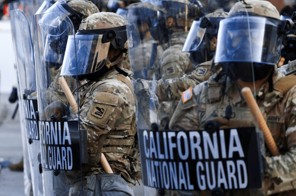 National Guard troops wear gas masks during protests against federal immigration sweeps, in Los Angeles, California, U.S., June 12, 2025. REUTERS/David Swanson/File Photo