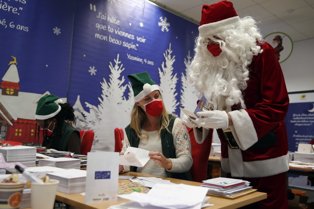 A postal worker dressed as Santa, talks with co-workers who call themselves 'Elves'  in Libourne, southwest France.
