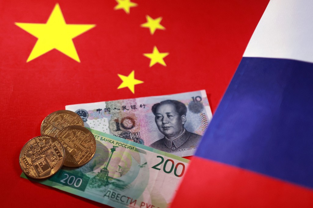 Chinese and Russian flags, Ruble, Yuan banknotes, and representations of cryptocurrencies are seen in this illustration taken September 12, 2025. REUTERS/Dado Ruvic/Illustration