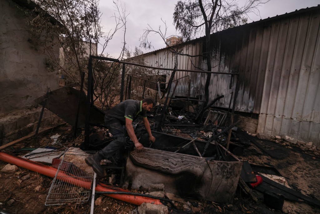 Photo by JAAFAR ASHTIYEH / AFP  A Palestinian man inspects parts of a burnt house after an Israeli settlers attack in the village of Beit Lid, east of Tulkarm in the occupied West Bank on November 11, 2025.