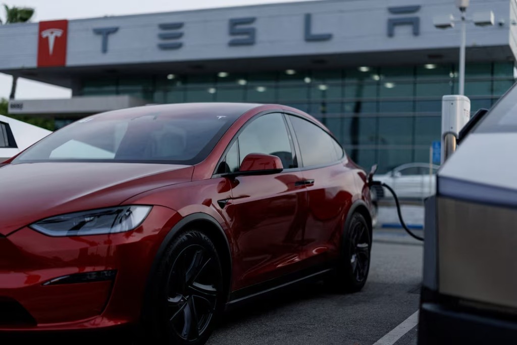 A Tesla model Y is shown charging at a Tesla dealership in Buena Park, California, U.S., January 28, 2026. REUTERS/Mike Blake/File Photo