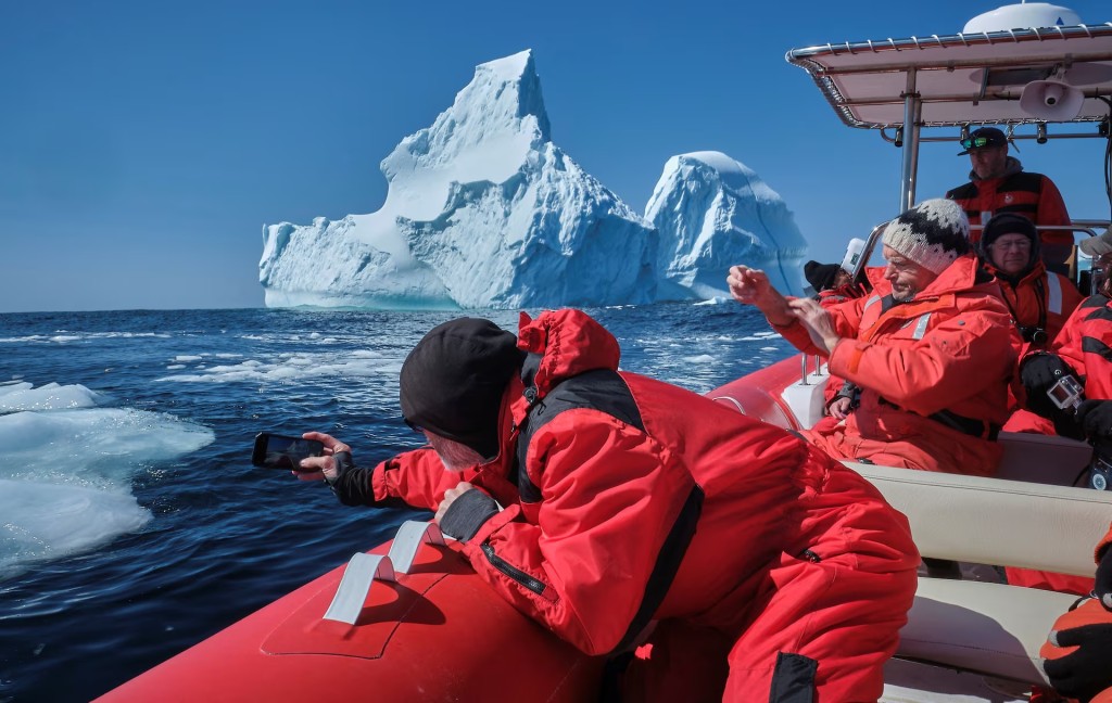 Tourists photograph pieces of an iceberg that drifted south on the Labrador Sea from Greenland in Saint Lunaire-Griquet, Newfoundland, Canada, May 27. REUTERS/Greg Locke