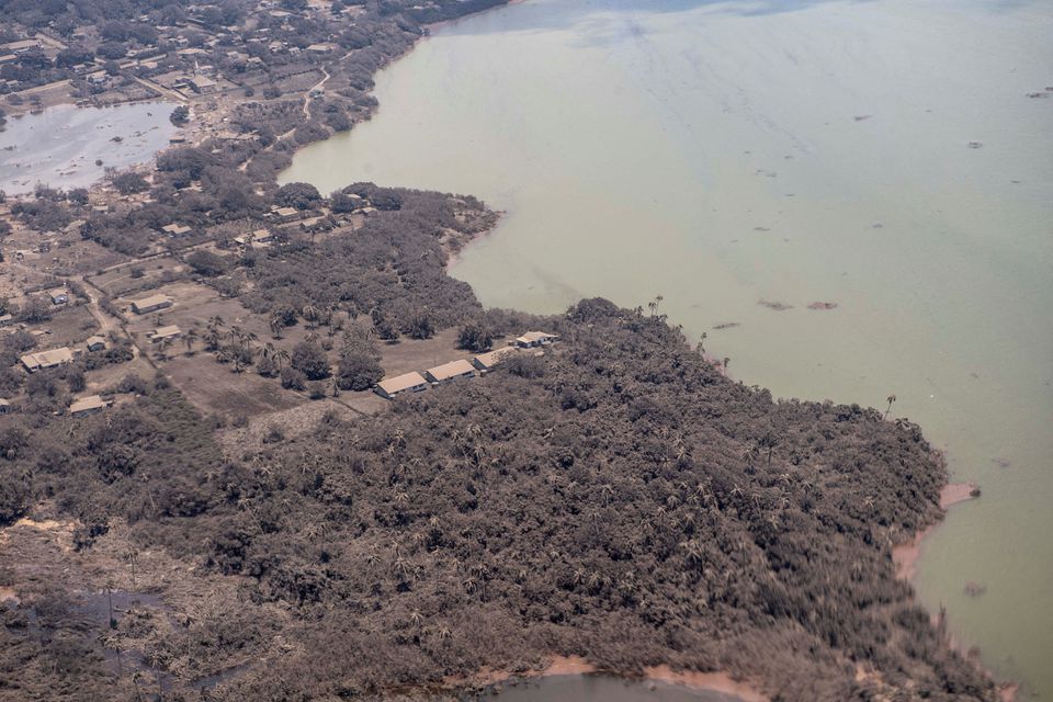 View from a New Zealand Defense Force P-3K2 Orion surveillance flight shows ash covered homes and vegetation over Nomuka in Tonga. (Reuters) View from a New Zealand Defense Force P-3K2 Orion surveillance flight shows ash covered homes and vegetation over Nomuka in Tonga. (Reuters)