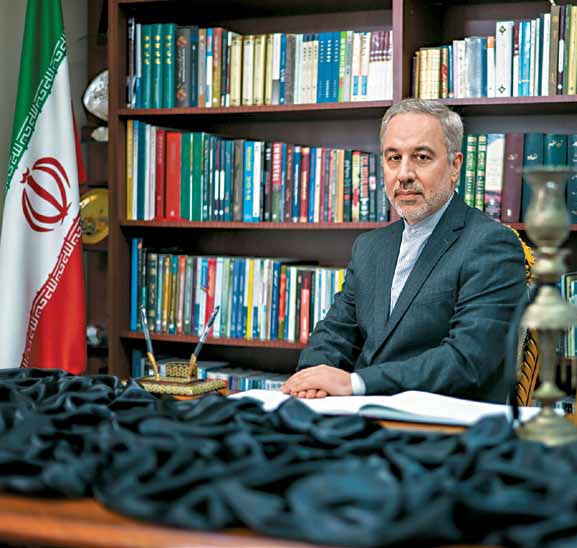 Hassan Doutaghi sat behind a book of condolences with a black cloth placed in front, which offers a somber mood. (Kaho Ho)