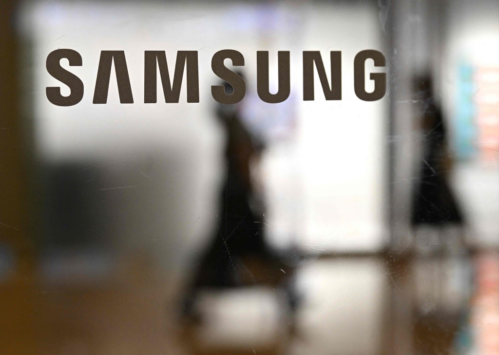 The logo of Samsung Electronics is displayed on a glass door at the company's Seocho building in Seoul on May 20, 2026. AFP