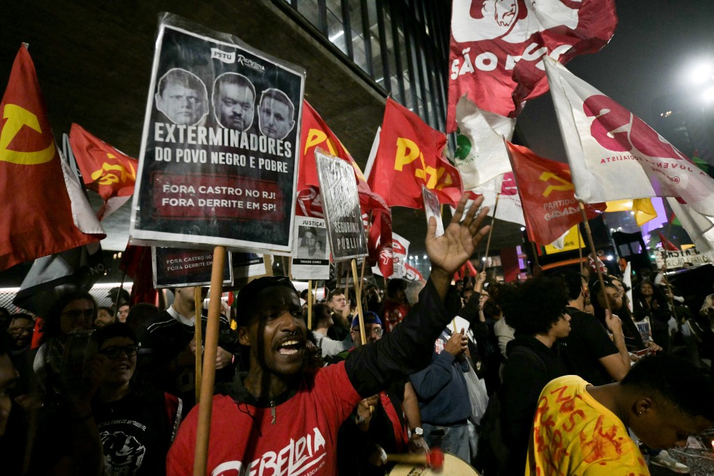 People take part in a protest in Sao Paulo, Brazil on October 31, 2025, to demand justice for victims of a massive police raid that left at least 117 suspected criminals and four police officers dead. (Photo by Nelson ALMEIDA / AFP)