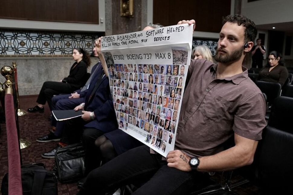 People hold a banner with pictures of victims of crashed Ethiopian Airlines flight 302 Boeing 737 MAX 8 during Senate Commerce, Science, and Transportation Committee hearing about Boeing’s commitment to address safety concerns in the wake of a January 2024 mid-air emergency involving a new 737 MAX, on Capitol Hill in Washington, D.C., U.S., April 2, 2025. REUTERS/Ken Cedeno