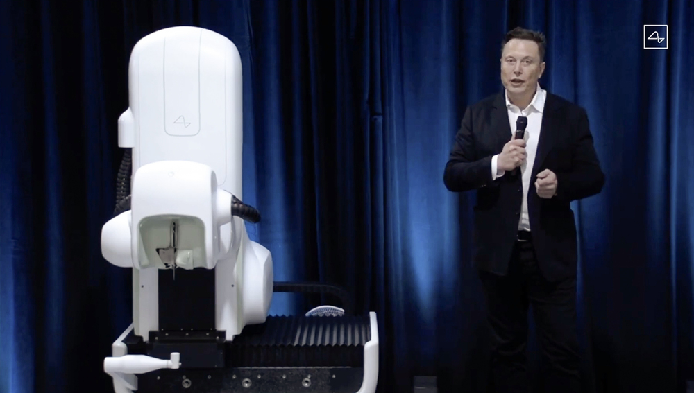 This video grab made from the online Neuralink livestream shows Elon Musk standing next to the surgical robot during his Neuralink presentation on August 28, 2020. (AFP) This video grab made from the online Neuralink livestream shows Elon Musk standing next to the surgical robot during his Neuralink presentation on August 28, 2020. (AFP)