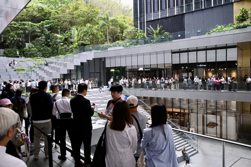 Visitors line up outside of the Pavilia Farm III's sales office