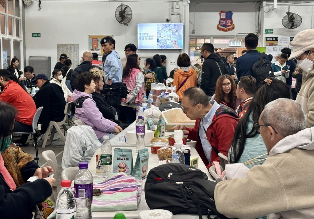Photo by TOMMY WANG / AFP  Residents take refuge in a temporary shelter near the Wang Fuk Court residential estate in Hong Kong's Tai Po district on November 26, 2025.